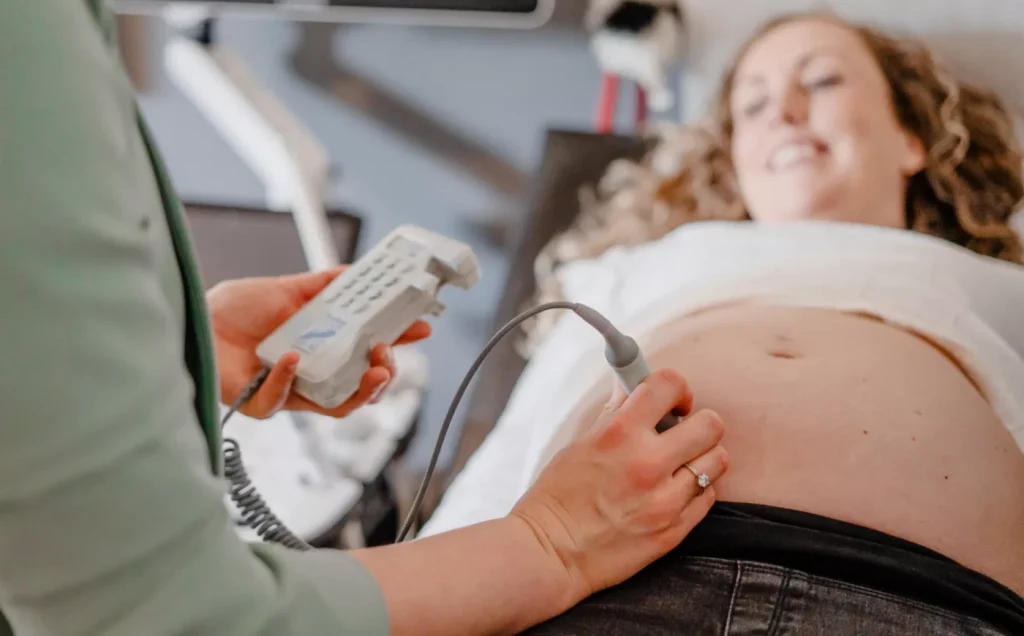 verloskundige luistert hartje van baby